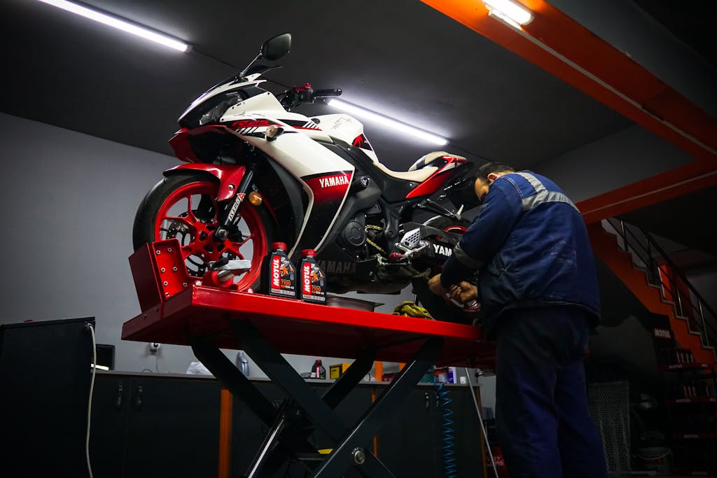 The Importance of Motorcycle Maintenance 1 Man performing Motorcycle Maintenance on a Yamaha